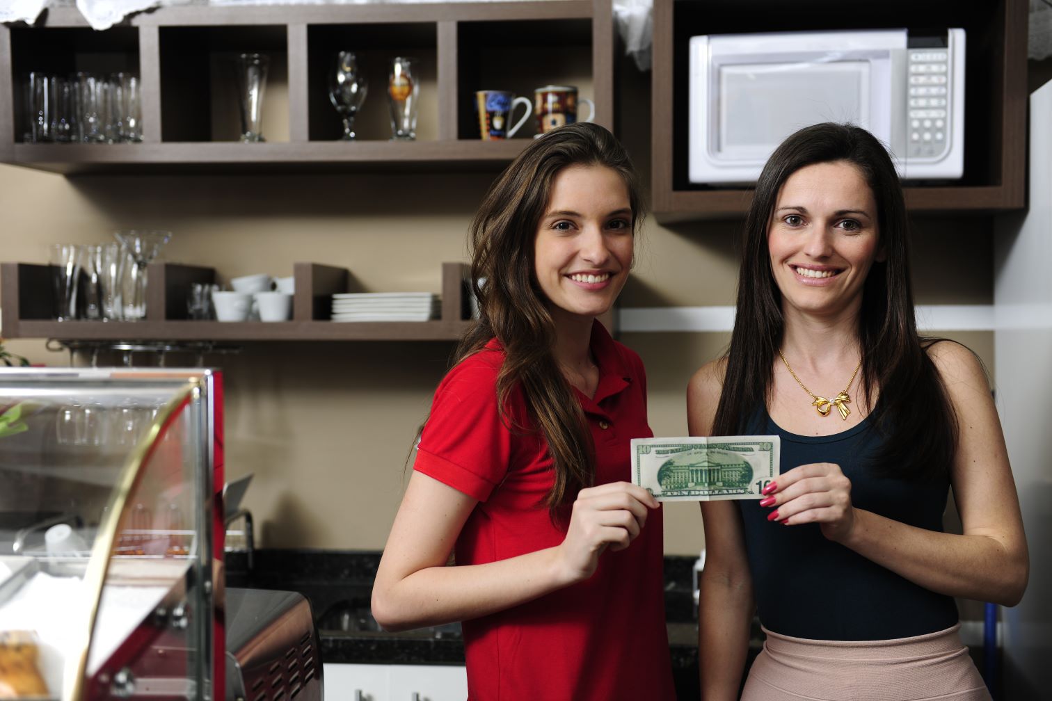 Women business owners holding money from loan